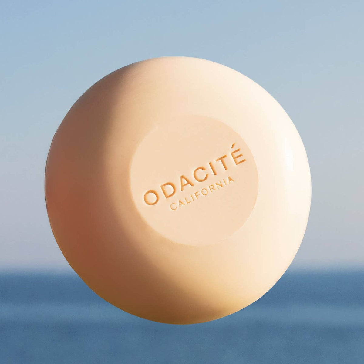 Shampoo bar of soap with 'ODACITé California' branding against a blurred natural background