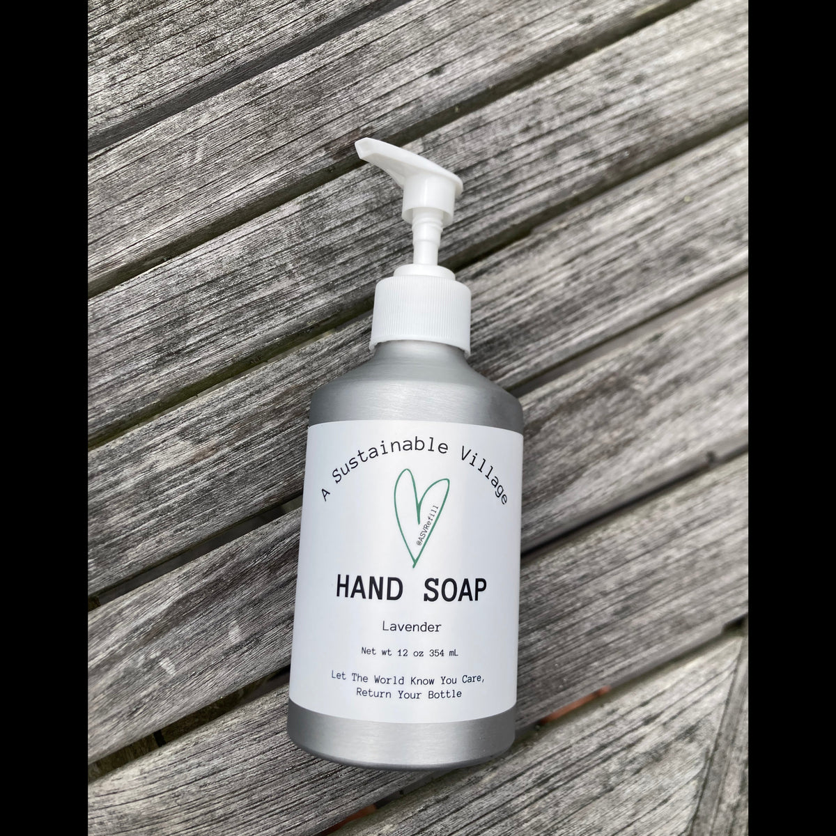 Hand soap bottle with pump on a wooden surface