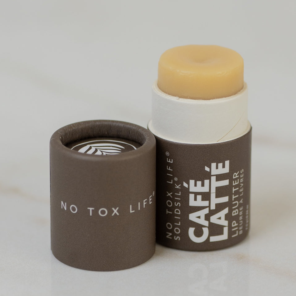 Lip balm with a brown container labeled 'No Tox Life' on a light background