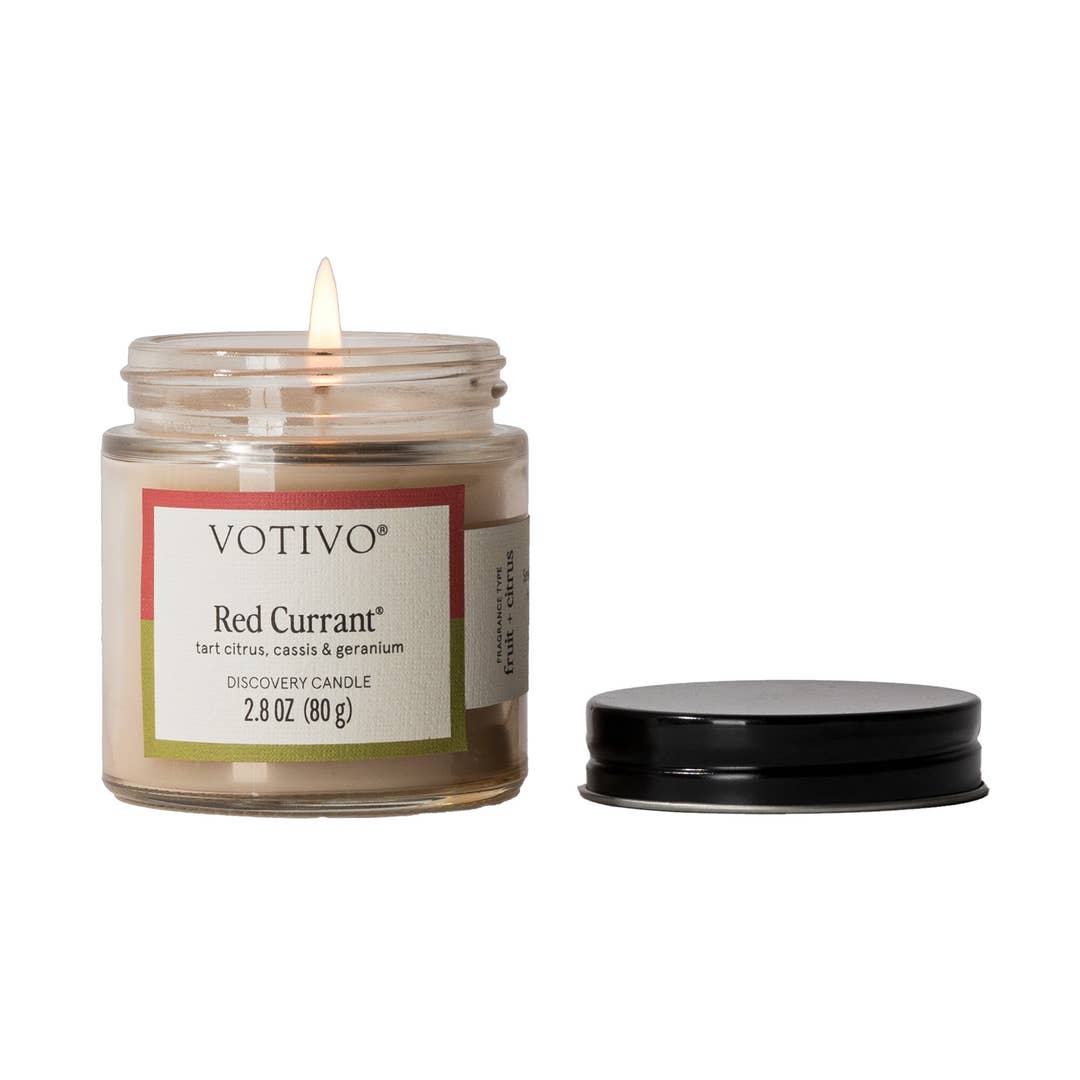 Votivo Red Currant candle in a glass jar with a black lid on a white background