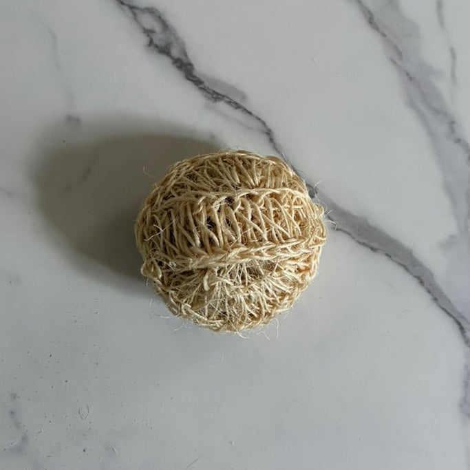 Natural fiber scrubber on a marble surface