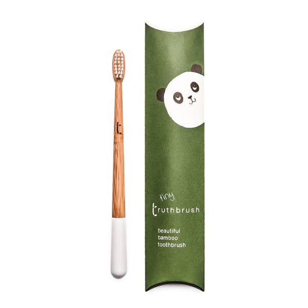 Bamboo toothbrush with a green packaging tube featuring a panda design on a white background.