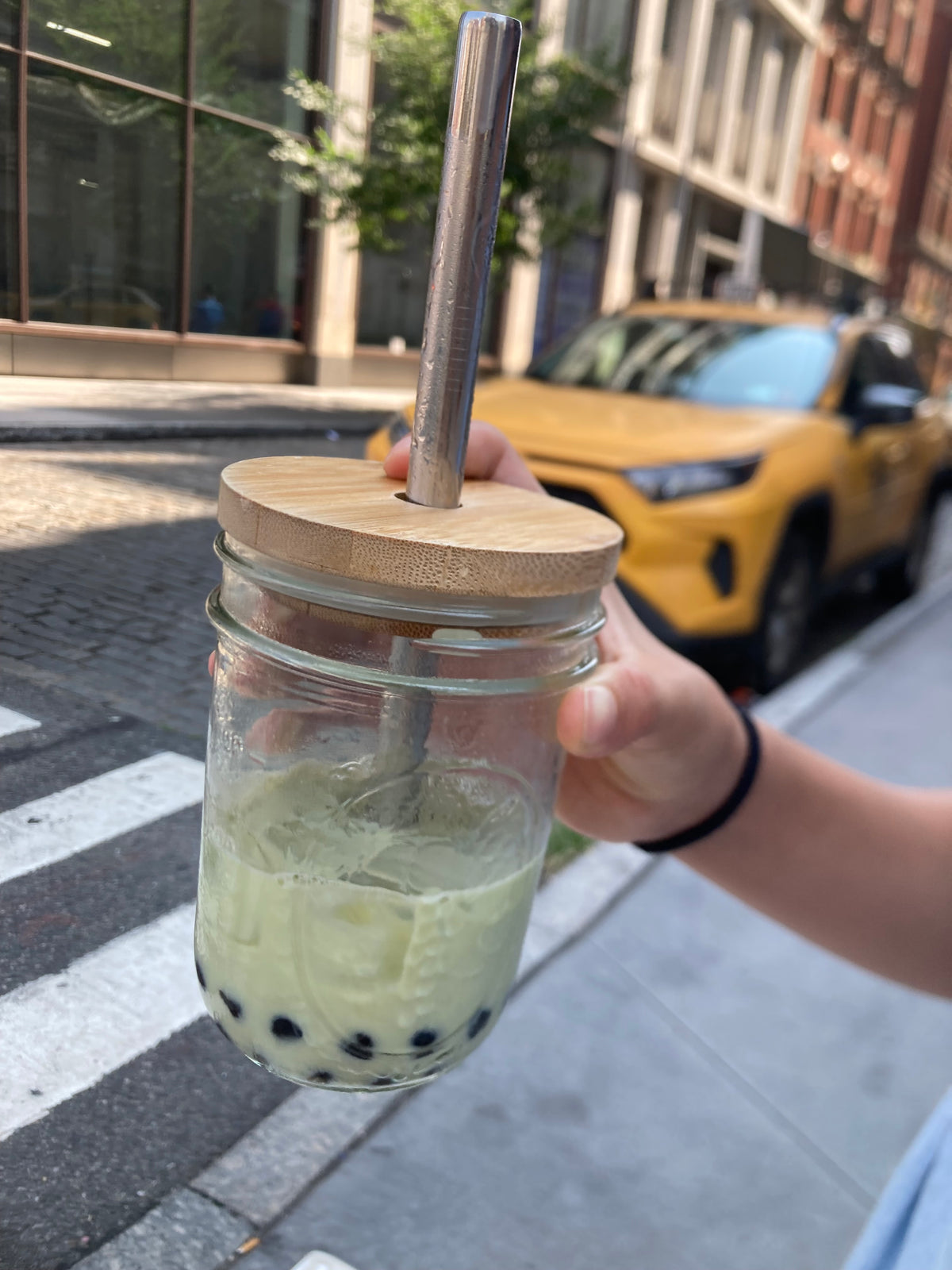 16 oz matcha latte boba drink in glass mason jar, bamboo lid and stainless steel straw 