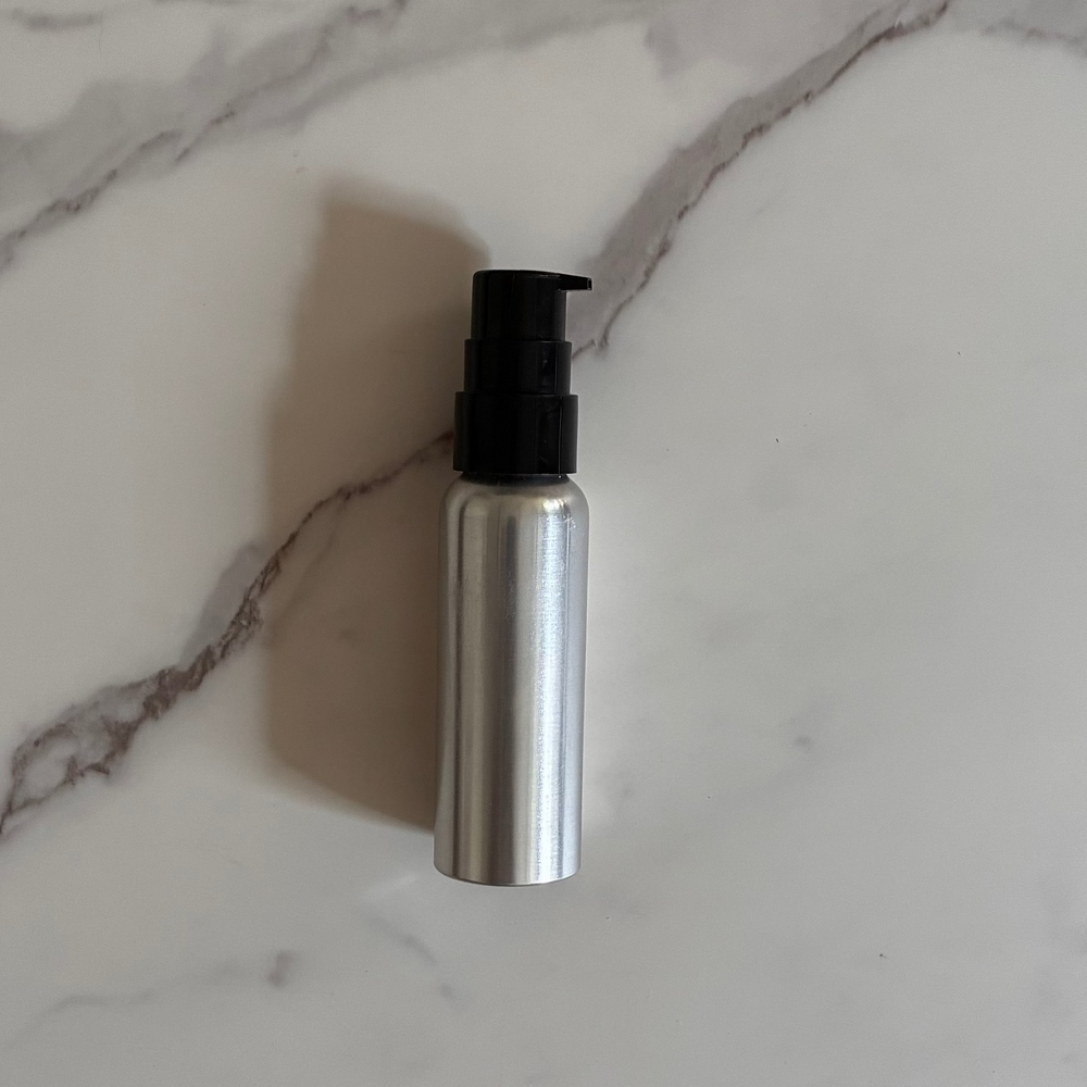 3 oz aluminum bottle with pump on marble counter
