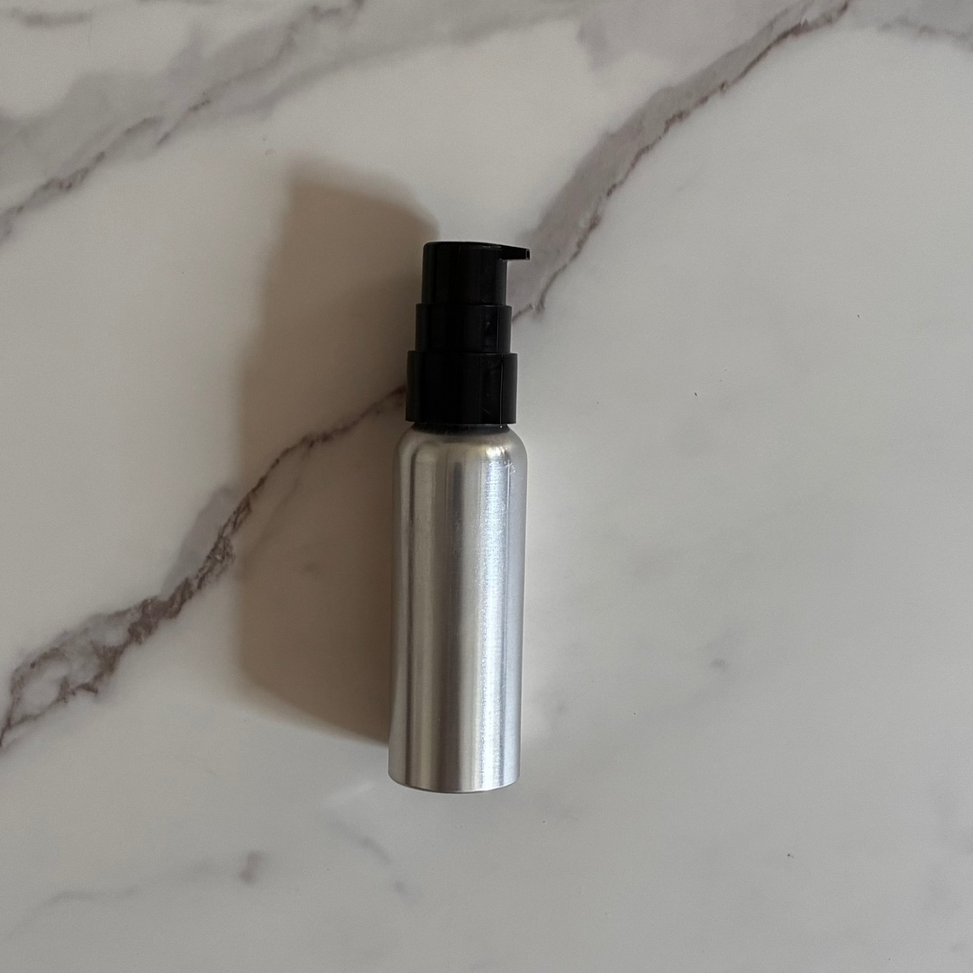 3 oz aluminum bottle with pump on marble counter