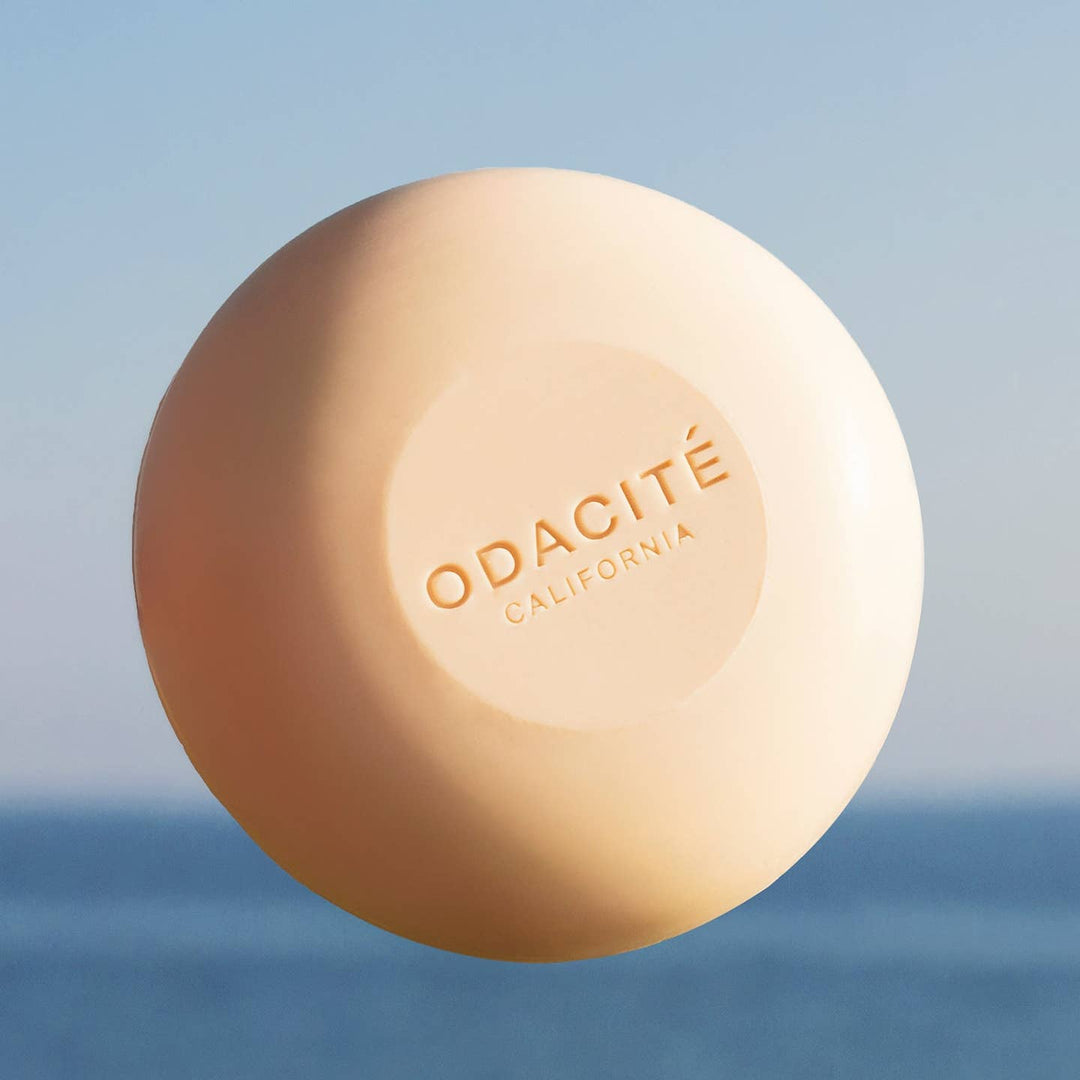 Shampoo bar of soap with 'ODACITé California' branding against a blurred natural background
