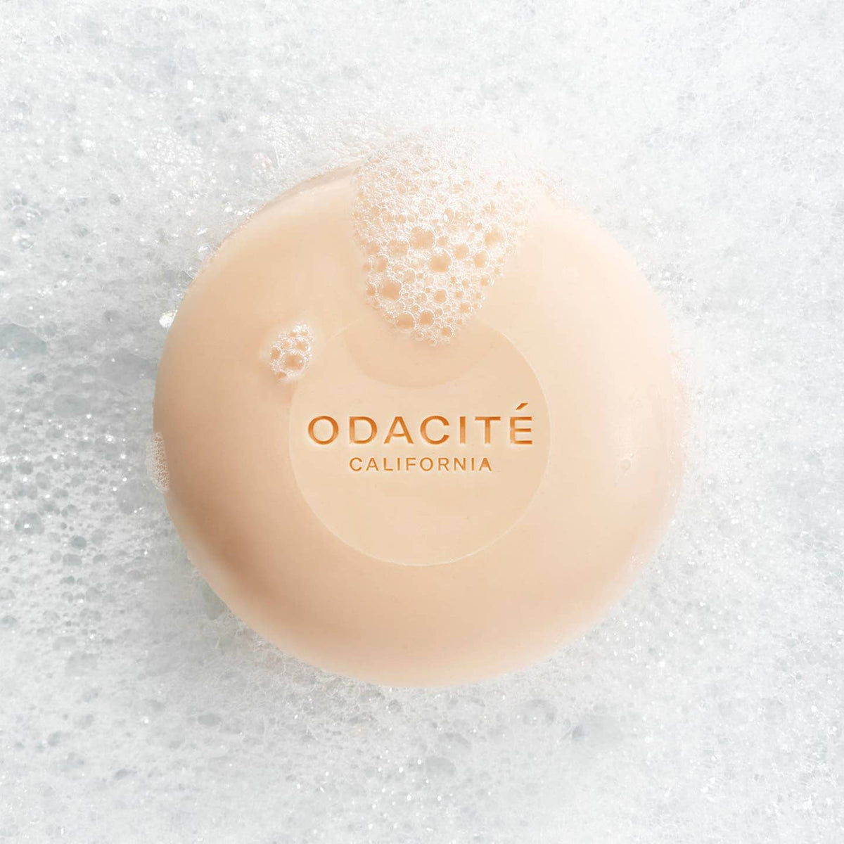 Bar of soap with 'Odacite California' branding on a textured white background