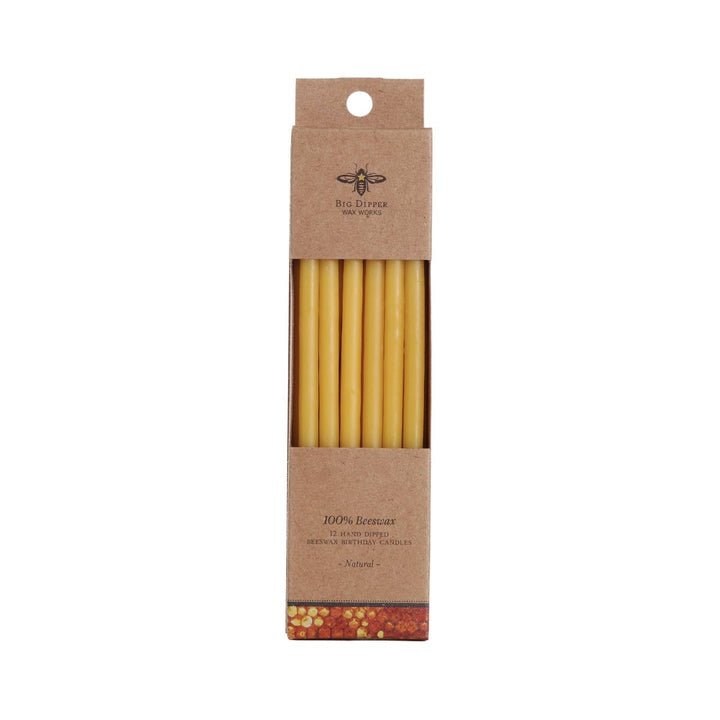 Pack of beeswax candles in a brown cardboard box on a white background