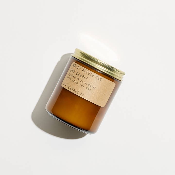 Scented candle with a wooden lid on a white background