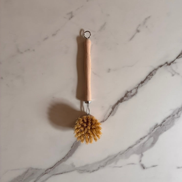 Bottle brush with wooden handle on a marble surface