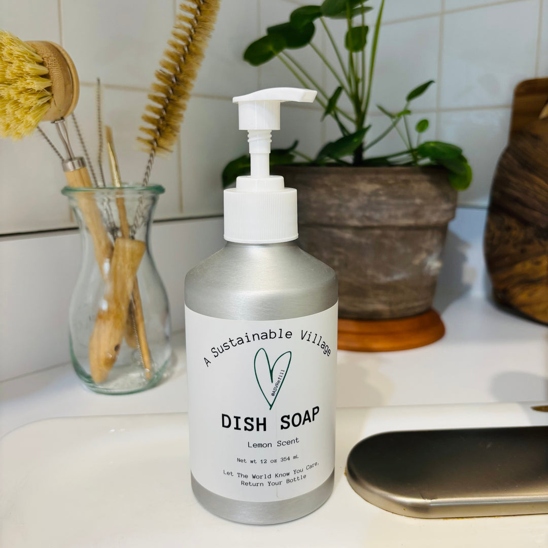 Bottle of dish soap on a kitchen counter with cleaning tools and plants in the background