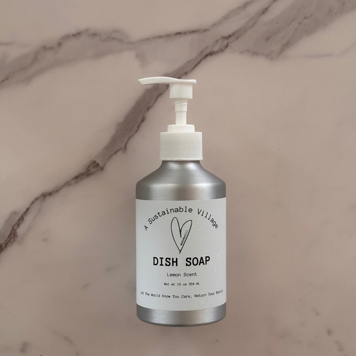 Lemon Dish soap in aluminum bottle with white pump on a marble surface