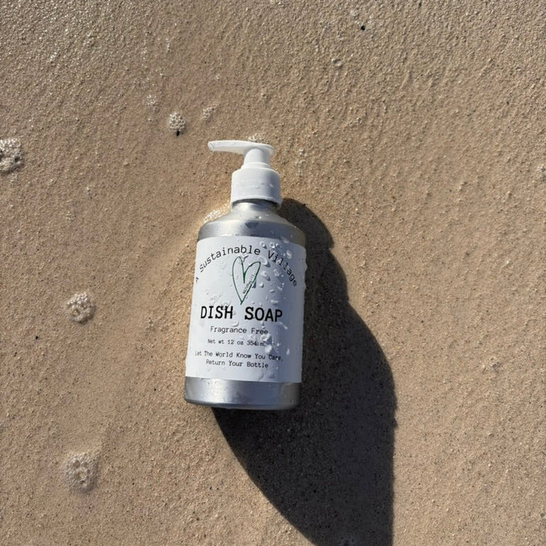 Bottle of dish soap on a sandy surface