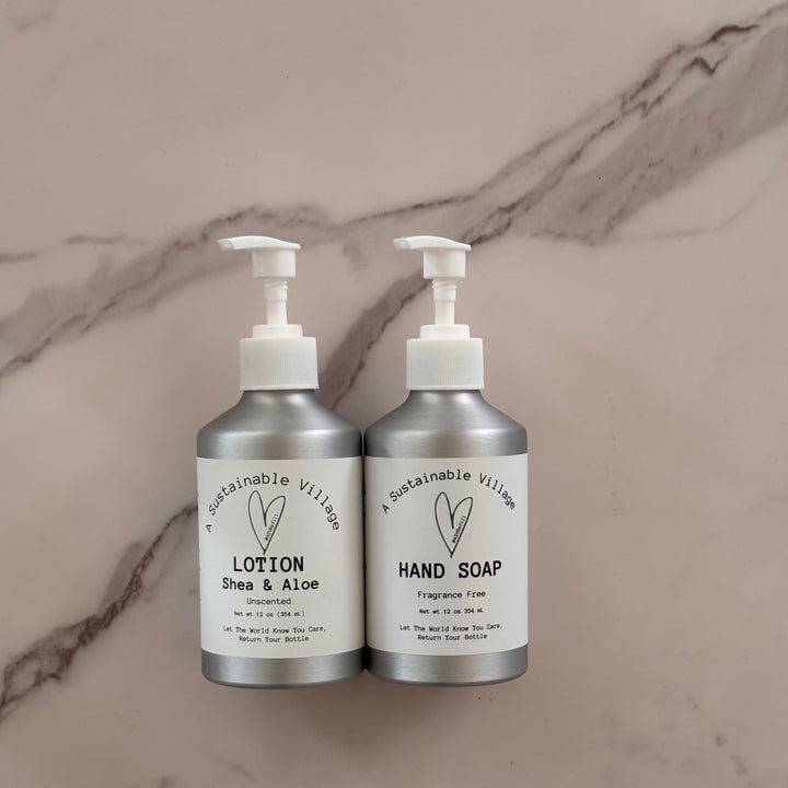 Two silver bottles of lotion and hand soap on a marble surface