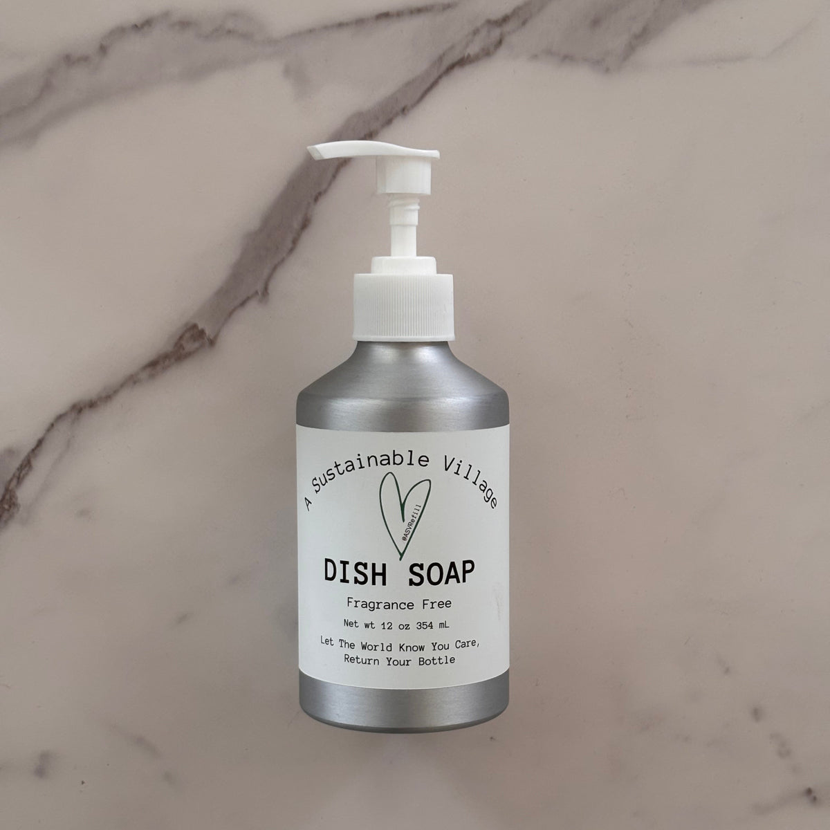 Dish soap bottle with pump on a marble surface