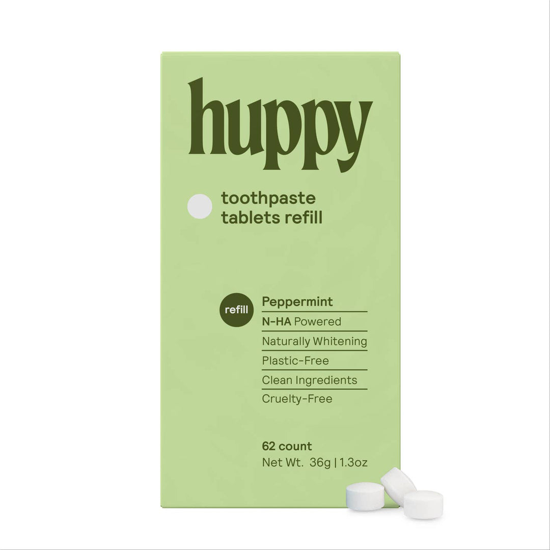 Green box of Huppy toothpaste tablets refill with white text on a white background