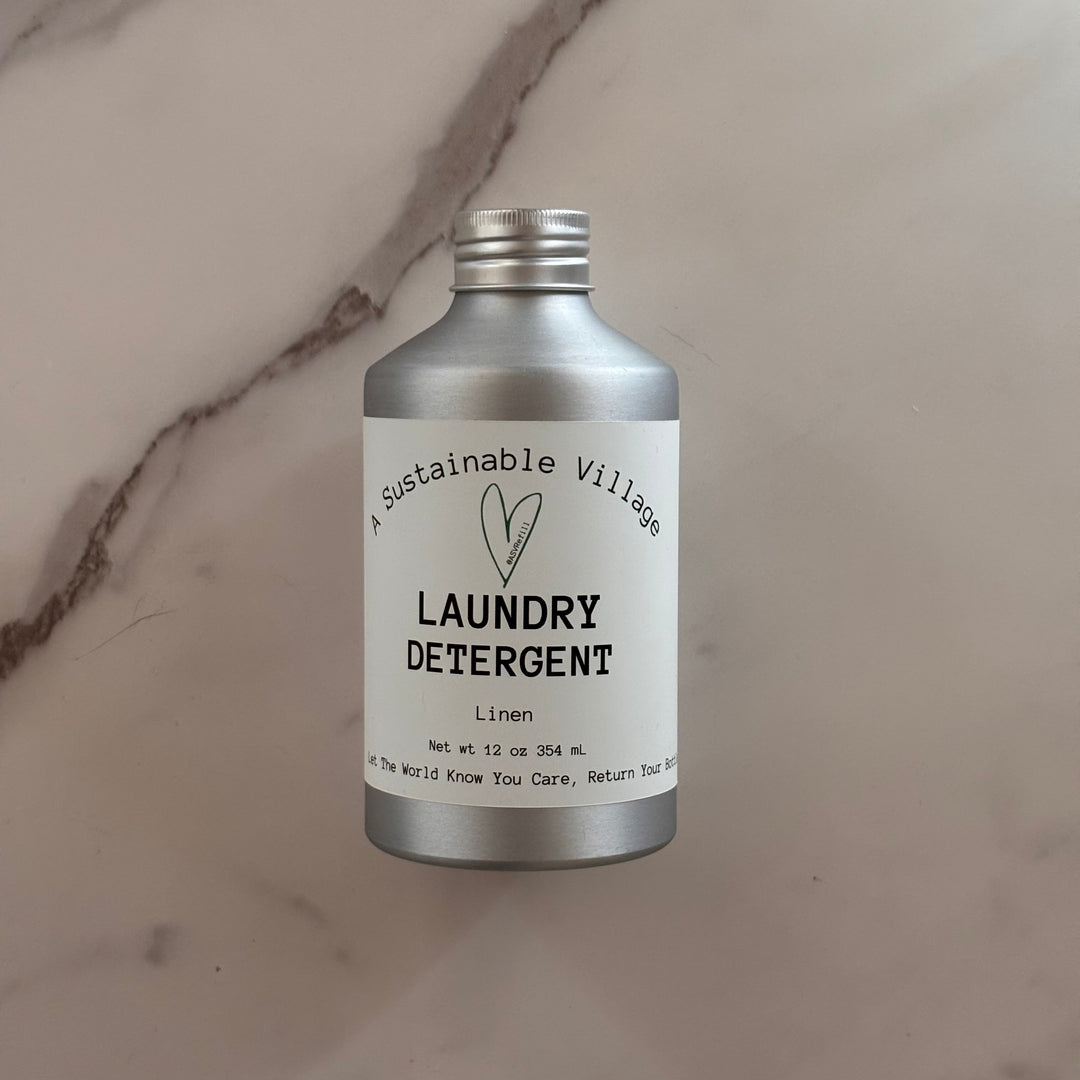 Aluminum bottle of laundry detergent on a marble surface