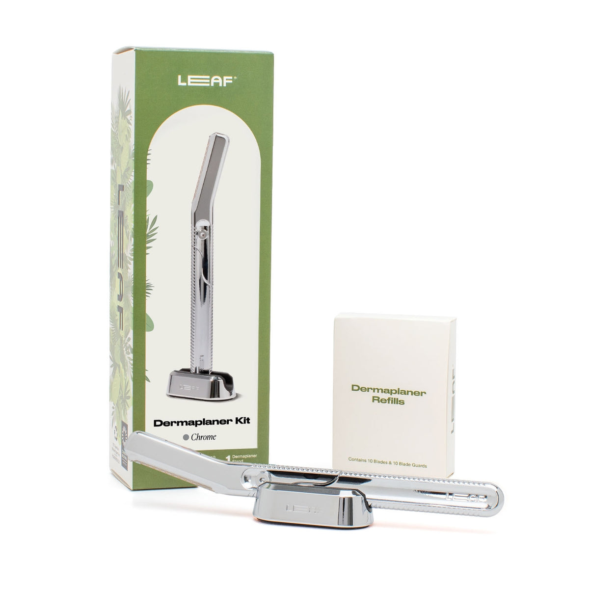 A Leaf Dermaplaner kit including a metal dermaplaner tool, blades, blade-guards, a precision clip, and packaging.
