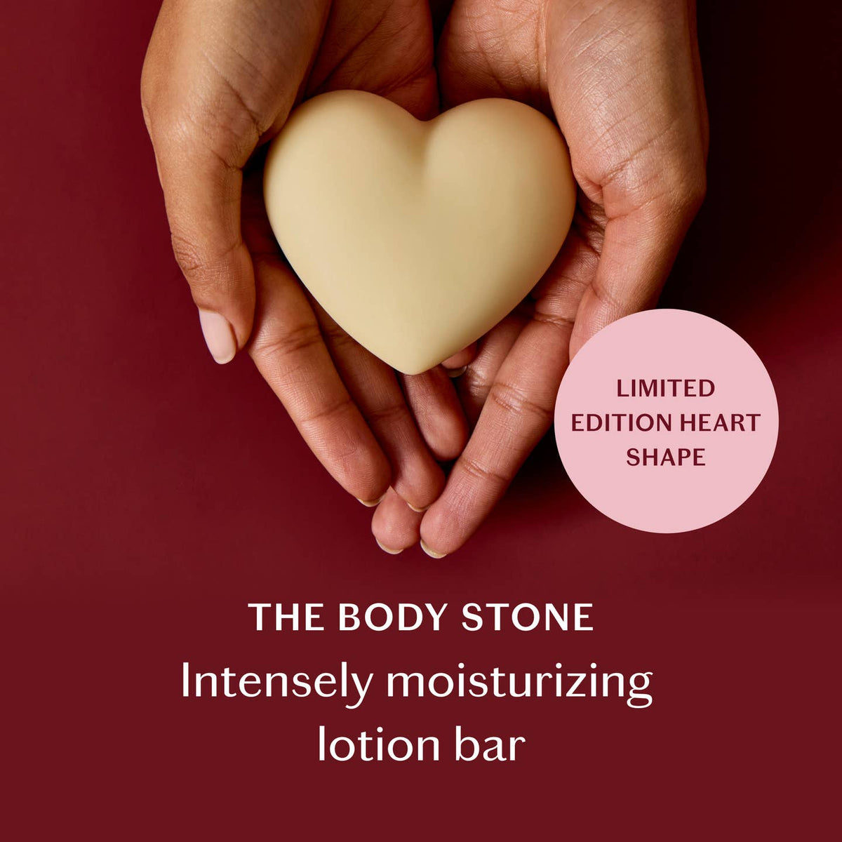 Heart-shaped body stone held in hands with promotional text on a red background