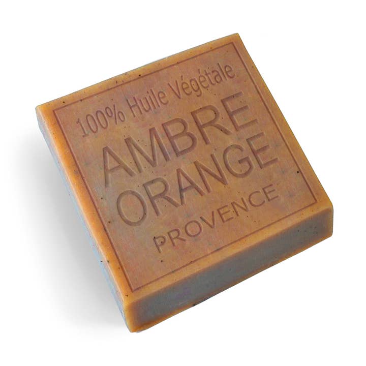 A rectangular bar of Provence Ambre Orange vegetable oil soap, featuring embossed text on a warm orange-brown surface, set against a plain white background.