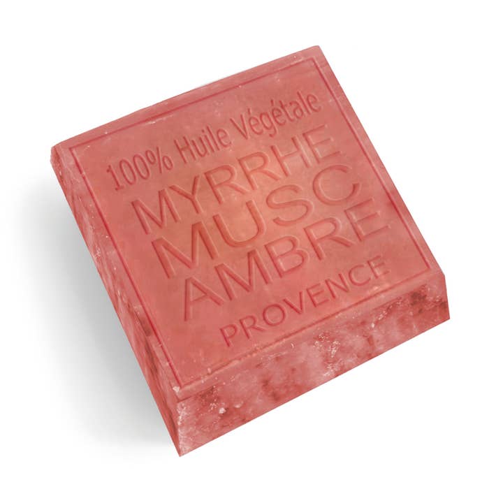 A single rectangular bar of natural body soap in a dusty rose pink color, embossed with French text reading '100% Huile Végétale', 'MYRRHE', 'MUSC AMBRE', and 'PROVENCE'. The soap is photographed at an angle on a clean white background with a soft drop shadow.