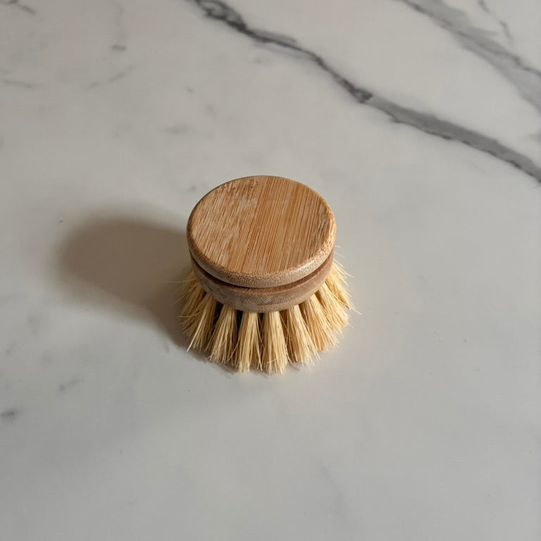 Bamboo dish brush on a marble surface