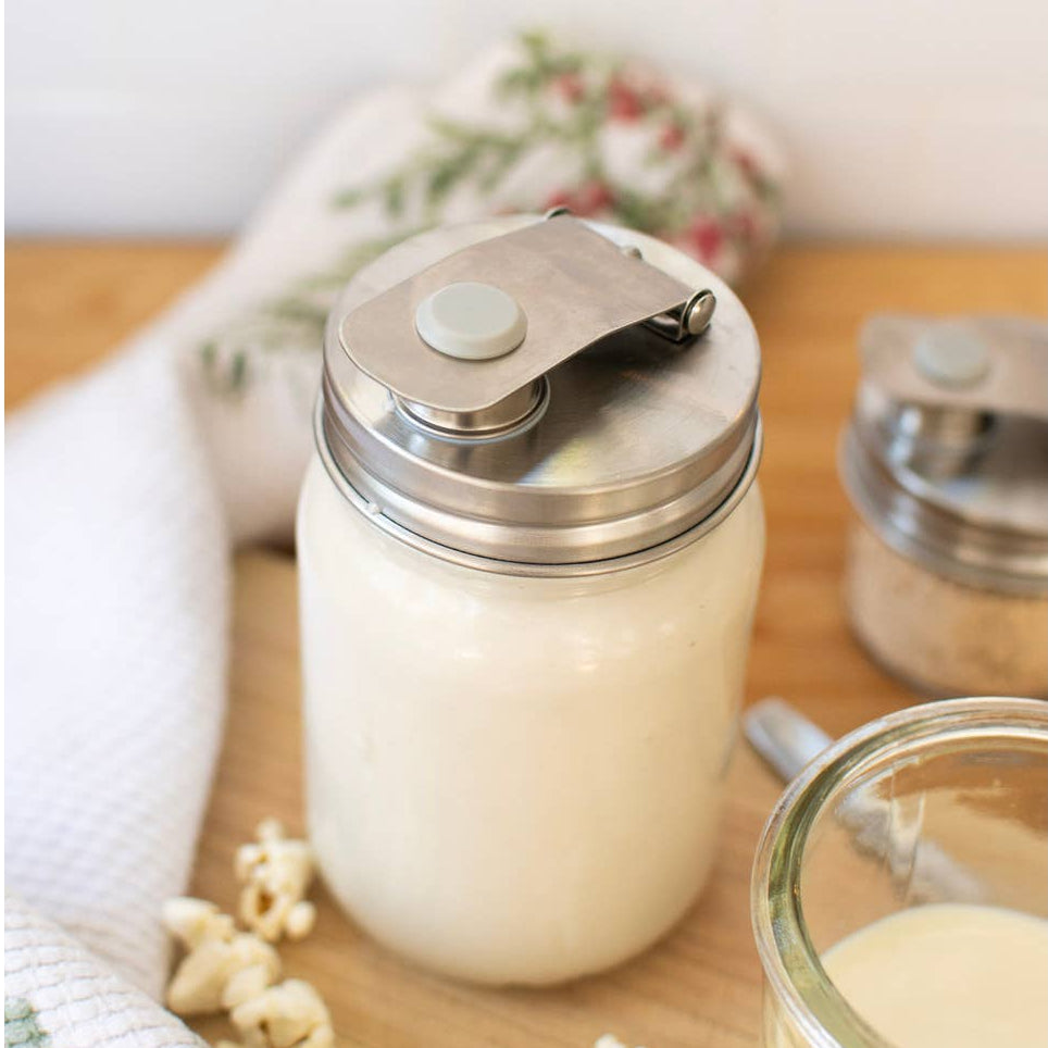 Jar of cream on a wooden surface with a white background