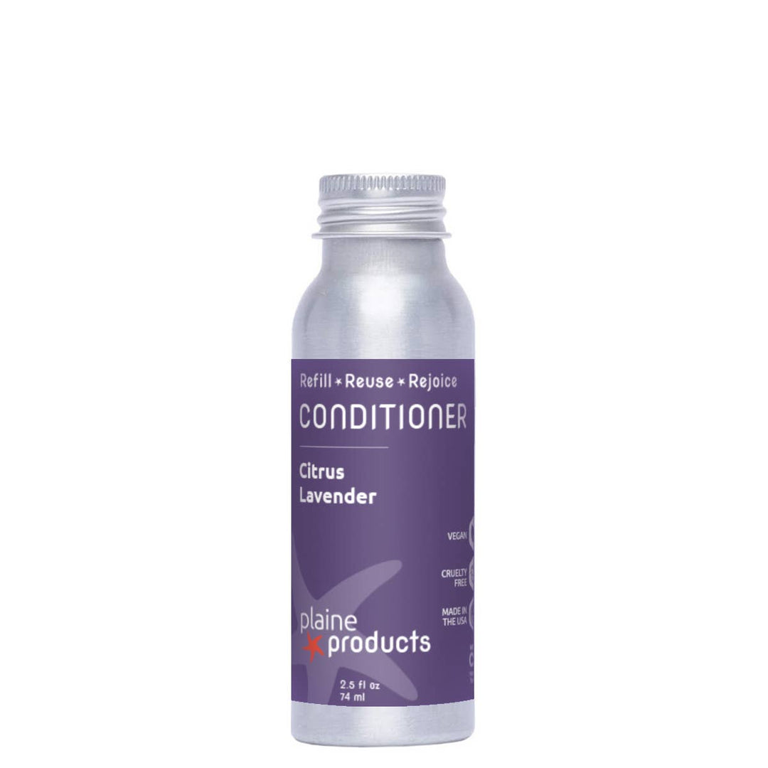 Silver bottle of conditioner with purple label on a white background