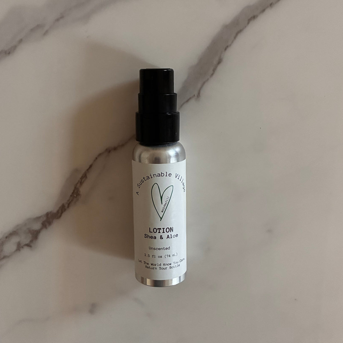 Travel size lotion bottle in aluminum bottle with a black cap on a marble surface plastic detox