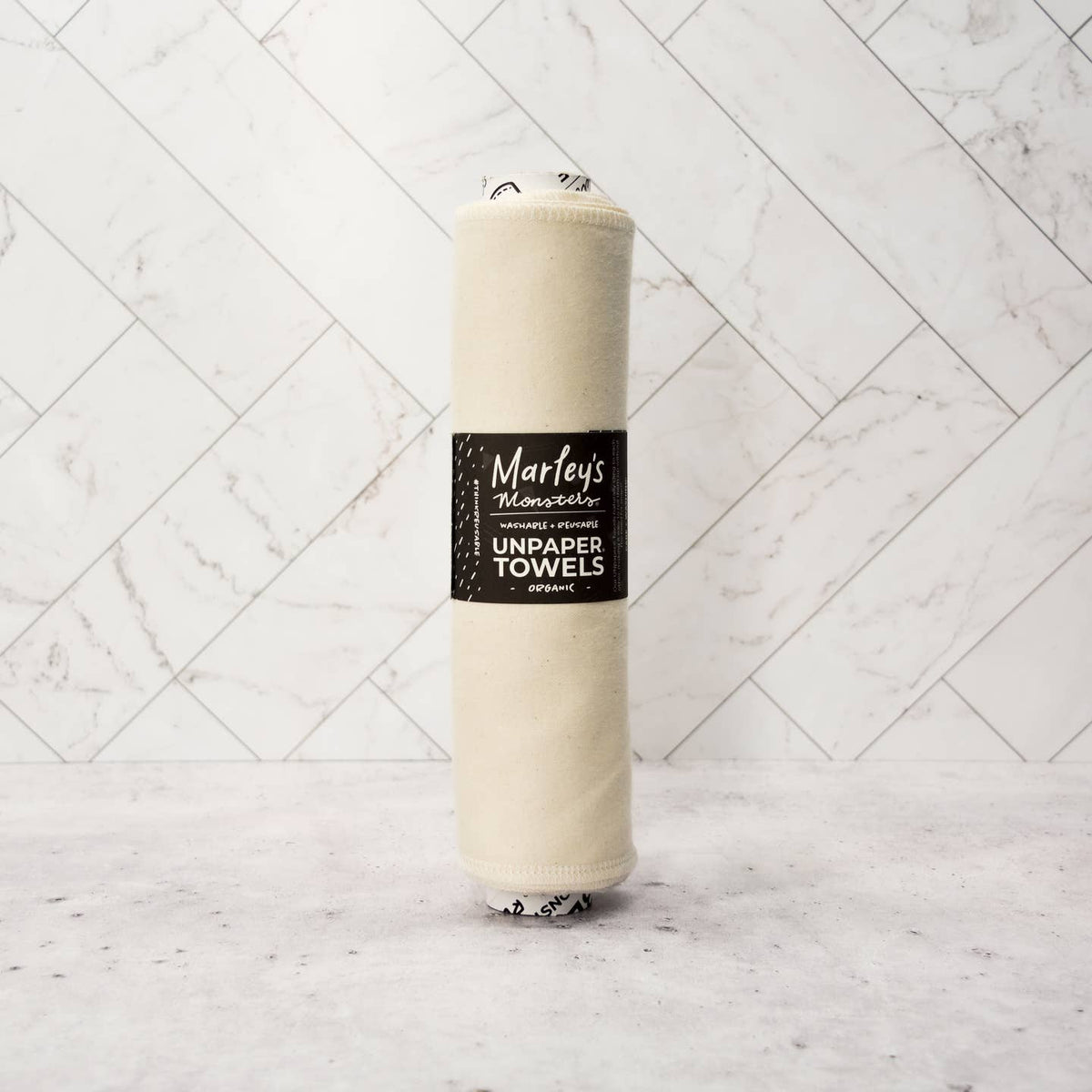 Roll of Marley's Monsters unpaper towels on a marble background