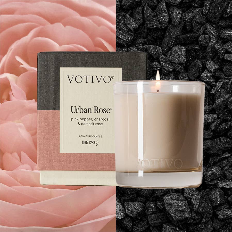 Votivo Urban Rose candle with packaging against a floral and black stone background