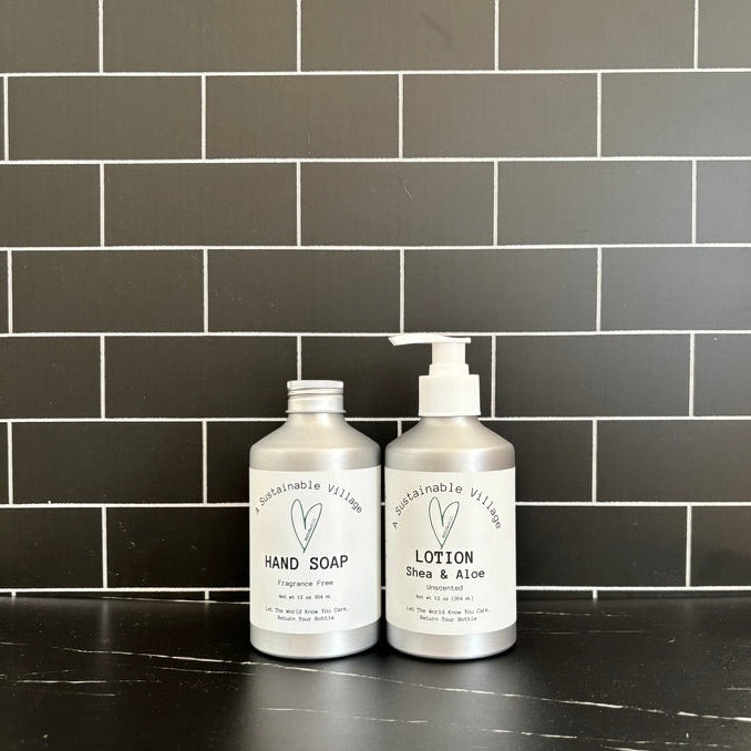 Two bottles of hand soap and lotion on a black marble surface with a dark tiled wall background.